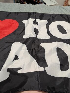 Black Banner with Large White Lettering and Red Heart